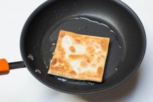 Cheesy Tortilla Pocket being fried on a skillet