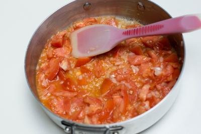 Tomatoes added to the sautéing onions in the deep skillet