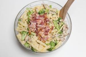 Creamy Chicken Pasta with Broccoli in a bowl with bacon added to it