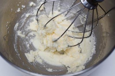 Sugar and butter being whisked together in a KitchenAid mixer