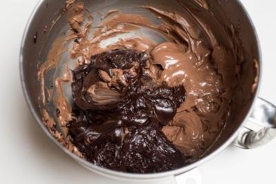 Chocolate and whipping cream mixture added to the beat nutella and butter in the mixing bowl