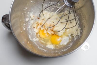 Eggs and vanilla extract added to the eggs and butter in the KitchenAid mixture
