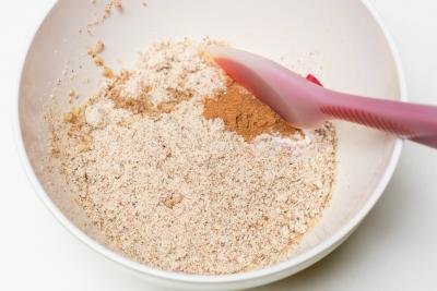 Dry ingredients being mixed together in a bowl with a spatula