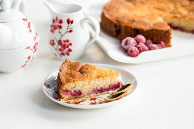 Quick Berry Coffee Cake slice on a plate with a spoon besides the slice