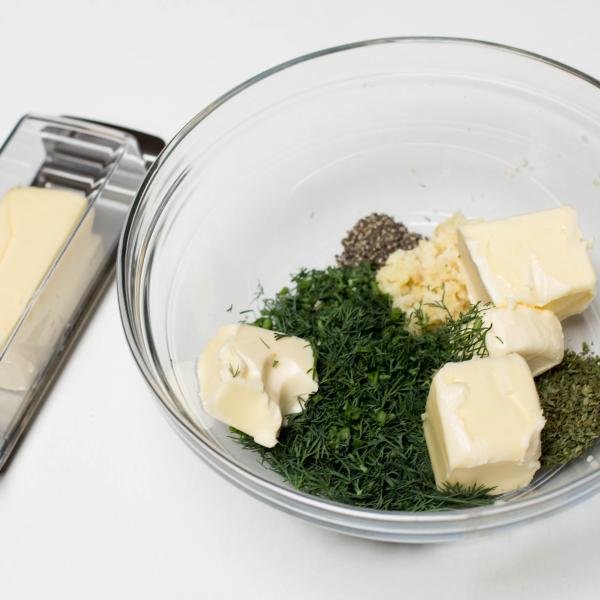 Butter added into the bowl with herbs and seasoning