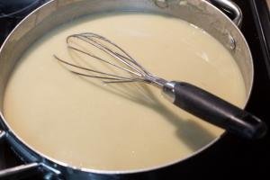 Gravy mixture in a pot with a whisk