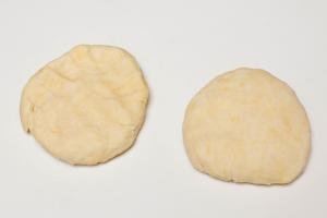 Dough divided into 2 equal pieces on the table