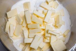 Butter added into the flour mixture in a large mixing bowl