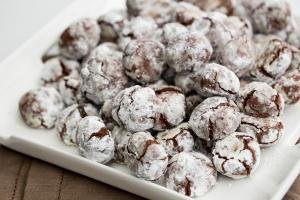 A pile of Chocolate Crinkle Cookies on a plate