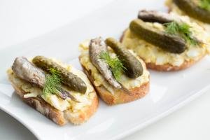 Egg & Sprats Canapes in a row on a plate