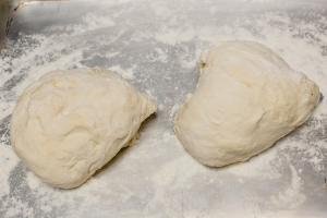 Dough formed into 2 oval balls on a floured surface