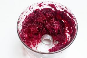 Beets in a food processor cut into thin slices