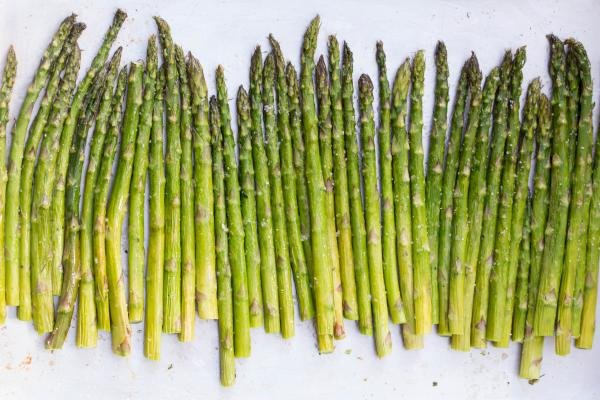 Asparagus seasoned on a baking pan