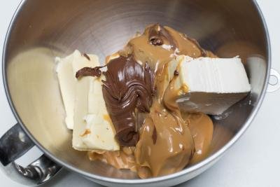 Butter, cream cheese, nutella and dulce de leche all placed into a large mixing bowl