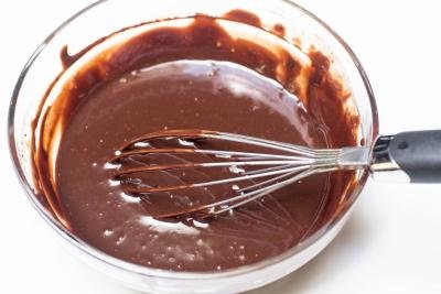Chocolate mixture in a bowl with a whisk in the bowl
