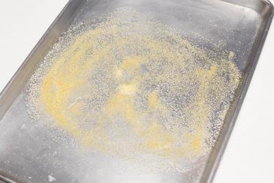 cornmeal on a sheet pan