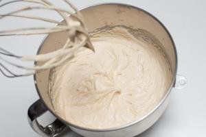 Cream mixture in a KitchenAid mixing bowl