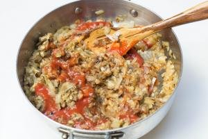 Eggplant and tomato sauce added into the deep skillet with the diced onions
