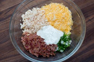 Canned chicken breast, sliced bacon, sliced green onions, cheese and ranch all placed into one bowl