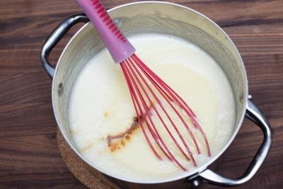 Into a pot with milk egg mixture, vanilla extract and sugar added in