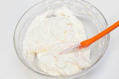 Cream mixed together in a bowl with a spatula