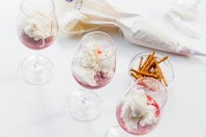 3 wine glasses each with strawberry mixture and ice cream in it