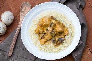 Cheesy Chicken and Mushrooms Gravy on pasta on a plate