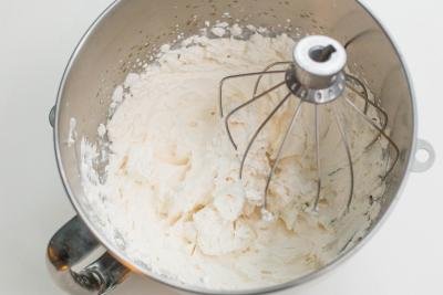 Cream mixture in a KitchenAid mixing bowl