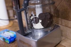 Oreo cookies placed into a food processor