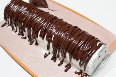 Chocolate mixture drizzled on top of the cake roll
