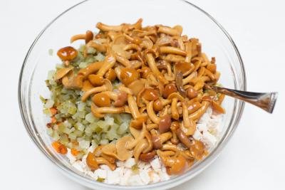Mushrooms, chicken,, pickles and carrots all diced and placed together in a bowl