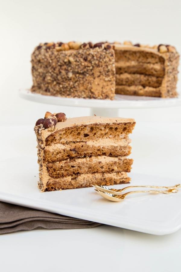 Golden Key Cake slice with the full cake behind it
