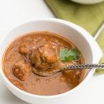 Tomato Lentil Soup with Meatballs in a bowl with a spoon