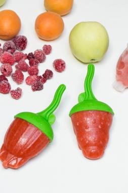 Healthy Popsicles with fresh fruits al around the popsicles