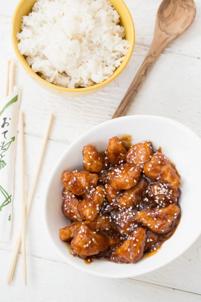 A bowl of rice and a bowl of P.F. Chang's Homemenu meats in a bowl