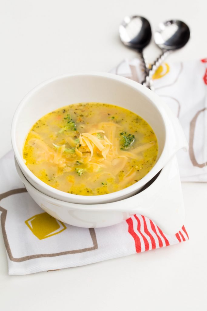 Quick Broccoli Cheddar Soup in a bowl standing on a kitchen towel