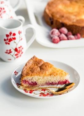Quick Berry Coffee Cake slice on a plate with a spoon besides the slice