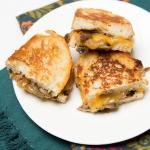 Mushroom and Cheese Sandwich on a plate cut in half