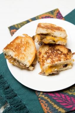 Mushroom and Cheese Sandwich on a plate cut in half