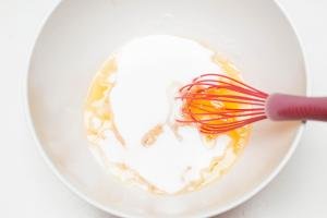 Eggs and sugar in a bowl being whisked together