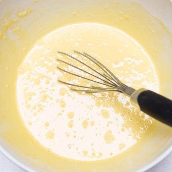 Batter in a bowl being mixed with a whisk