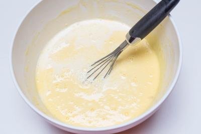 Batter in a bowl being mixed with a whisk