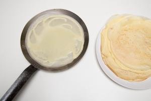Perfect Crepes on a skillet and layered on a plate