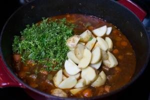 Potatoes and parsley added into the pot with the soup mixture