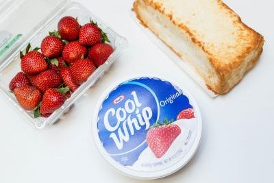 Ingredients on the table; strawberries, cool whip and angel bread