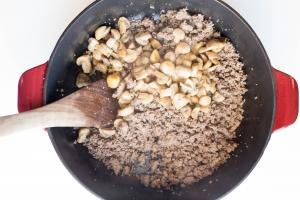 Ground beef and mushrooms in a ceramic baking pan