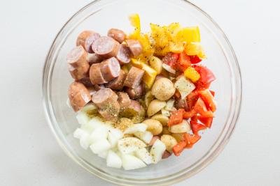 One Pan Sausage and Vegetable Bake ingredients in a bowl