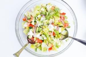 Greek Salad in a bowl with 2 spoons