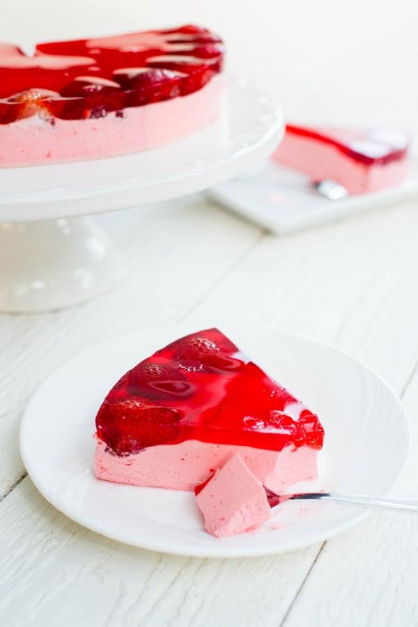Strawberry Jello Cake Dessert slice on a plate