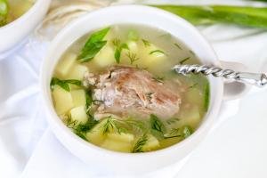 Cooked soup with cooked turkey neck.